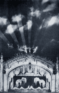 photo of the proscenium arch of the Paradise Theater, showing light show projected on the theater's domed ceiling