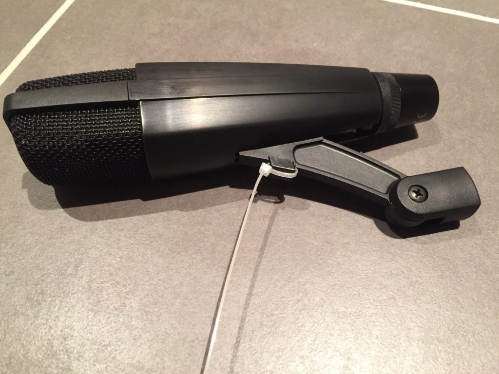 Sennheiser MD421 microphone with a zip tie wrapped around the mount's release button