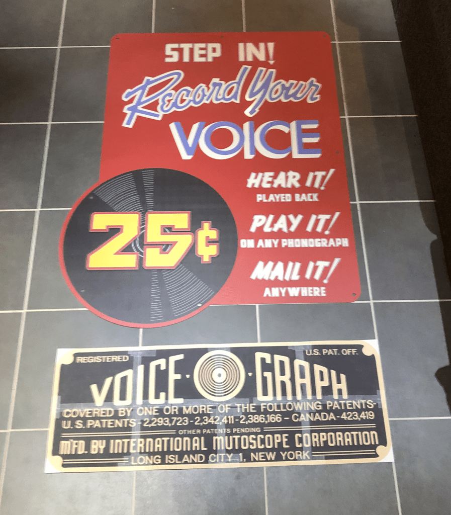 Paper patent plate mockup on the floor with RECORD YOUR VOICE sign