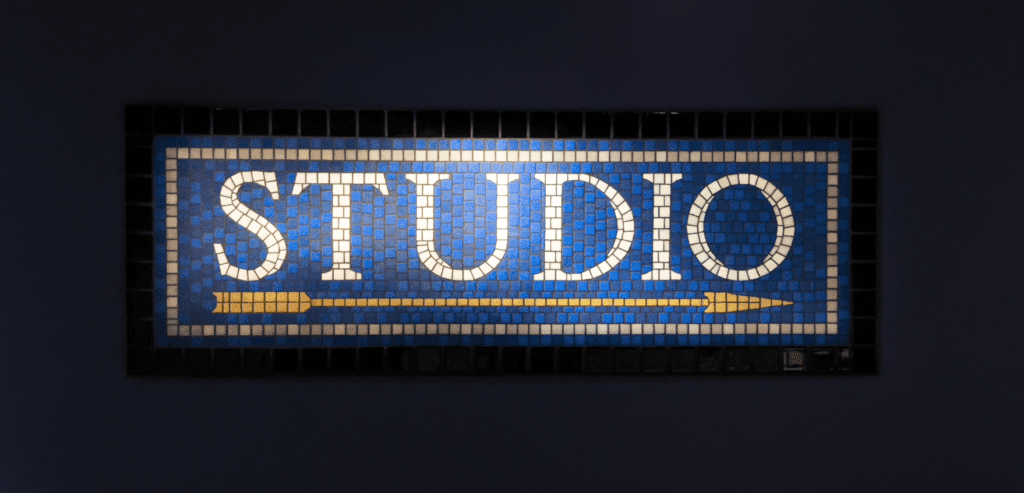 NYC subway style mosaic tile STUDIO sign on the wall